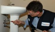 Plumber in Peoria tightens intake line for a pedestal sink